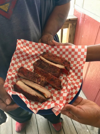 Roman and Shakira Heard hold a basket of ribs. They own Heard's BBQ & Soul Food in Maplesville.